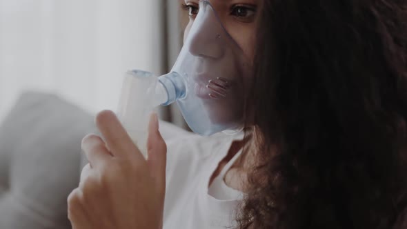 Closeup Young African American Woman Putting on Oxygen Mask Having an Asthma alt