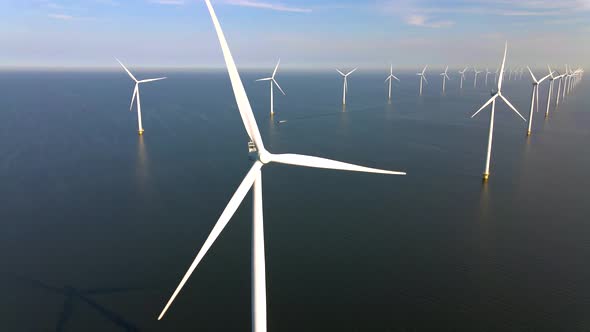 Wind Turbines in the Early Morning Wind Mill Park in the Netherlands alt