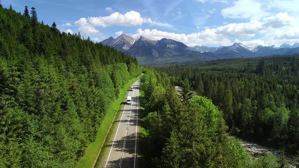 Aerial view of mountain twisted road truck or van driving.