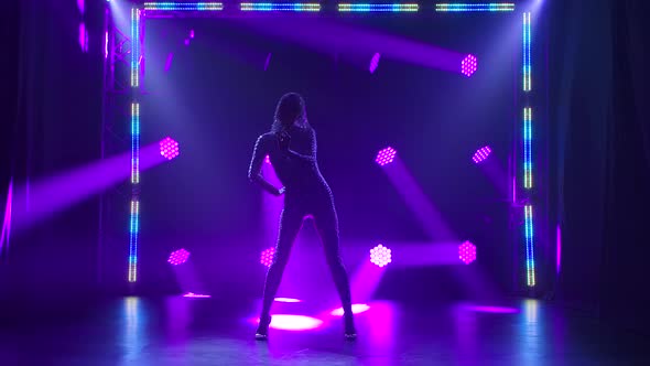 A Passionate Dance Performed By a Slender Young Woman. A Female Dancer in a Tight Fitting Suit with alt