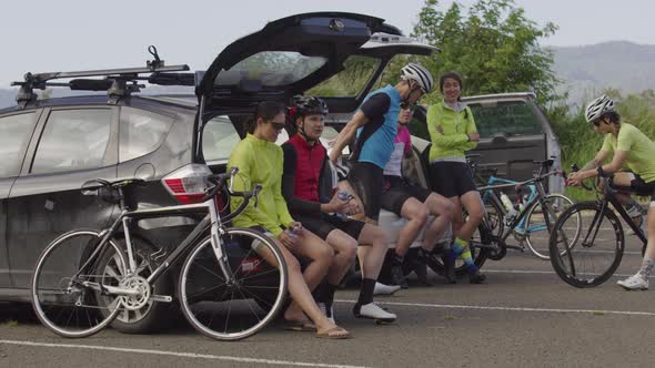 Group of cyclists taking break and preparing for ride.  Fully released for commercial use.