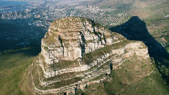 aerial top down view of Lions Head peak with Cape Town in background at sunset alt
