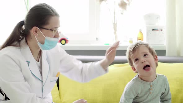 Medium Plan of Young Woman Nurse or Doctor Pediatrician of Caucasian Slavic Ethnicity Examines 23 alt