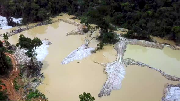 Drone footage of a mining pool in the middle of the Amazon rainforest in Brazil. alt