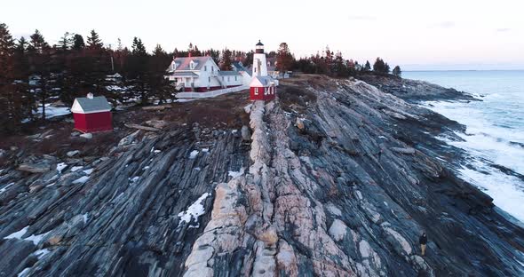 Aerial view from the edge of the bedrock inland highlighting the Grindel Point Light Islesboro Maine alt