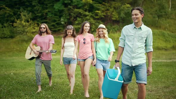 Happy Friends Having Fun Outdoors In Nature. alt