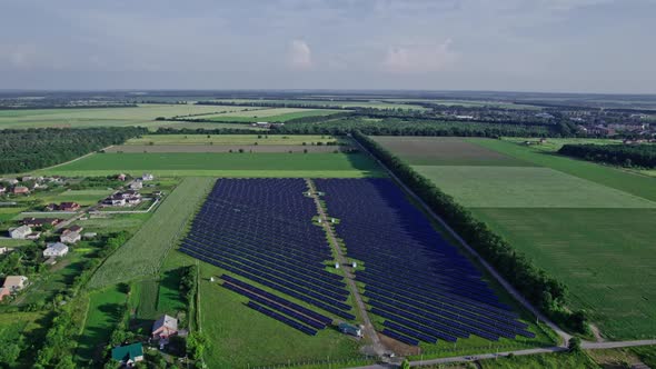 Aerial View of Solar Panels Stand in a Row in the Fields alt