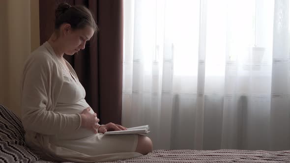 Authentic Cute Pregnant Woman Feeling Happy at Home with Belly alt