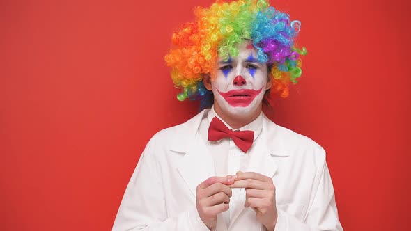 Portrait of a Sad Clown with a Painted Face on an Isolated Background