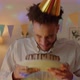 Slow Motion Portrait of Young Man in Party Hat Holding Birthday Cake Then Smashing It with Face in - VideoHive Item for Sale