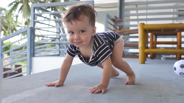 A Cute Baby 89 Months Old is Crawling Towards the Camera