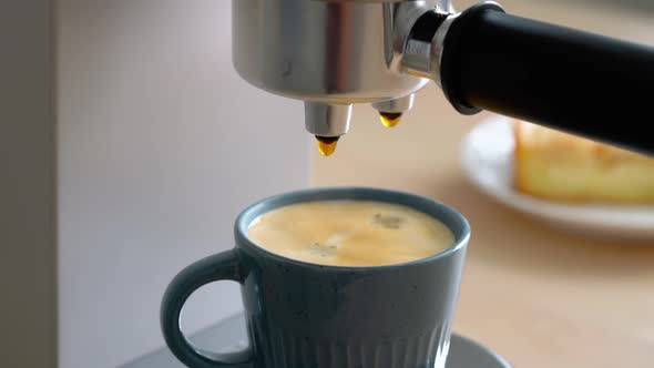 Morning Ritual at Breakfast with Pouring Coffee From Coffee Machine Drops of Espresso Dripping
