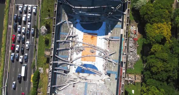 Drone Top View of Abandoned and Destroyed Gymnasium. Destroyed Stadium as camera Moves Up alt