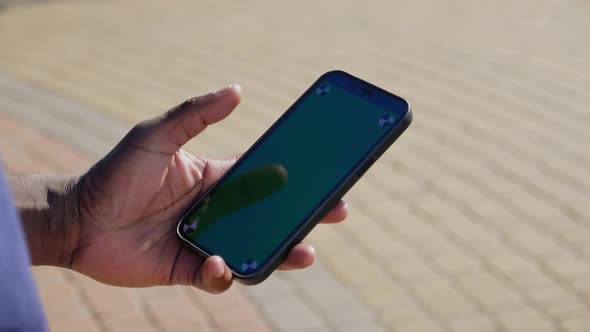 Afroamerican Man Finger Touches Smartphone Display with Chroma Key Green Screen alt