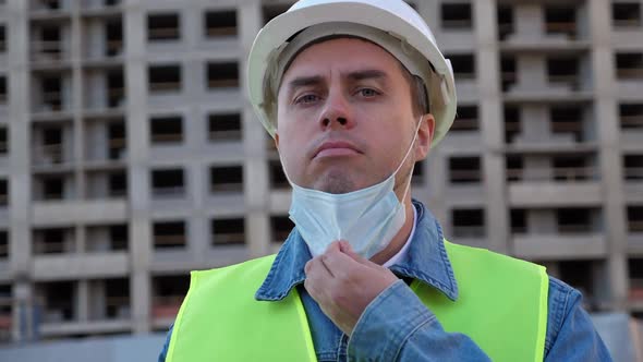 Worker Staff in White Helmet Put on and Put Off Medical Mask at Construction Site alt