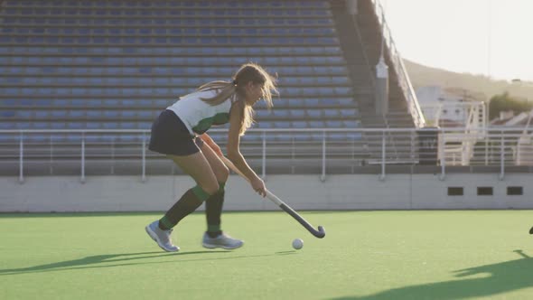 Female hockey players playing on the field alt