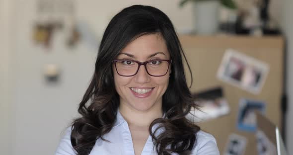 Portrait of woman at home office studio wearing a shirt and eyeglasses alt