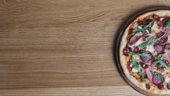 Appetizing Pizza on a Wooden Board in a Restaurant alt