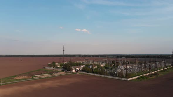 Quadrocopter flight over the power plant. Rows of poles, wires. City power station from above alt