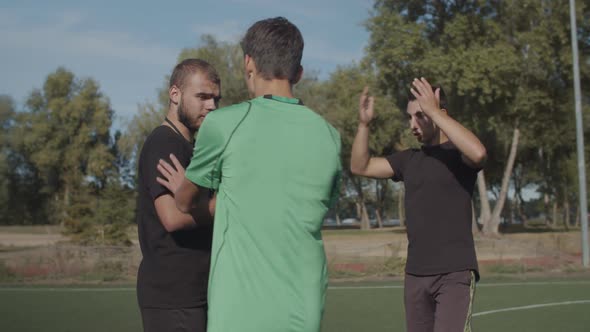 Soccer Team Arguing with Referee for Dismissal alt