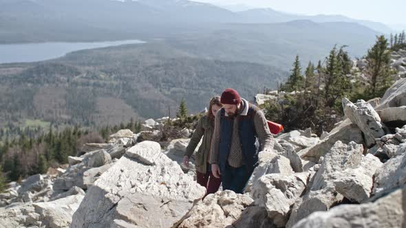 Couple Trying to Find Trail in Mountains alt