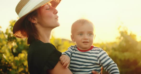 Portrait Happy Mother with Her Lovely Little Child in French Provence Vineyard During Summer Sunset alt