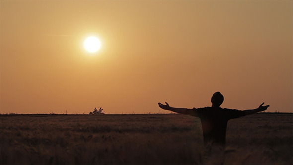 Raising Hands to the Sky During a Sunset