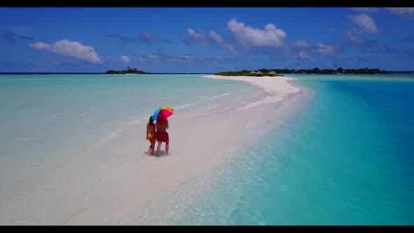 Young couple happy together on exotic lagoon beach trip by transparent water and white sand backgrou alt