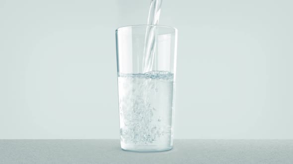Person Pours Water Into Glass alt