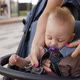 Mom Fastens the Baby in the Stroller for Safety on a Summer Day - VideoHive Item for Sale