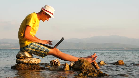 Successful Man Surrounded By the Sea. He Works for Himself, Combines Work and Rest