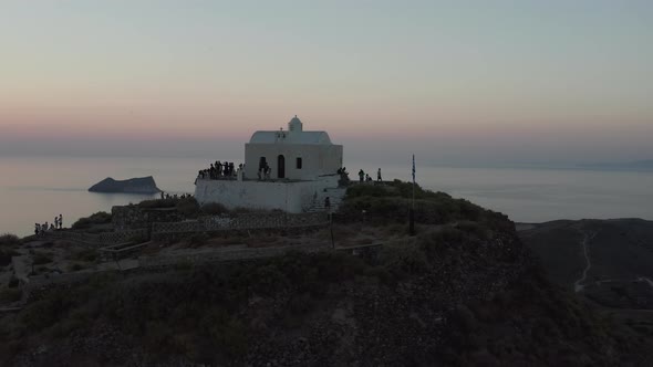 People Tourists Enjoying the Sunset From Church Viewing Point Over Island in Greece alt