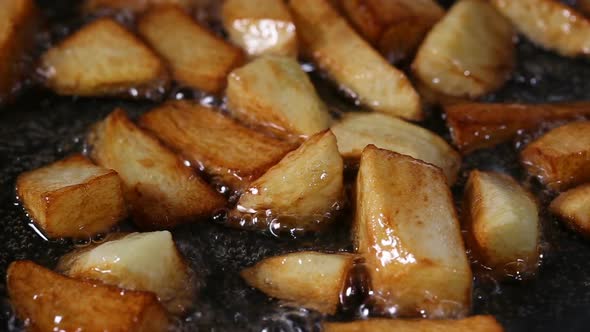 Close up view of Frying Fresh Raw chopped Potatoes In Pan alt