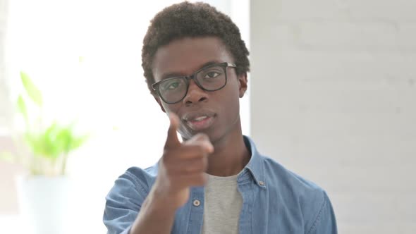 Portrait of Young African Man Pointing at the Camera and Inviting alt