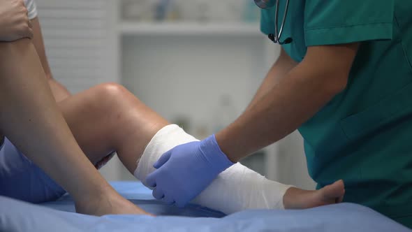 Professional Surgeon Applying Gypsum on Female Patient Leg, Trauma, Healthcare