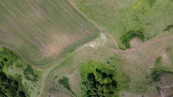 Scenic landscape shooting by drone. Aerial view of tourists track on the hill top. Natural beauty