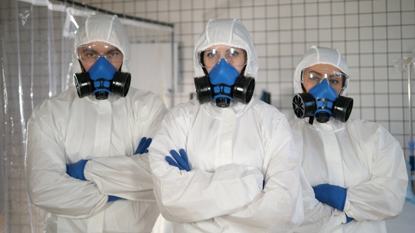 Doctors in a protective clothes standing together with alt