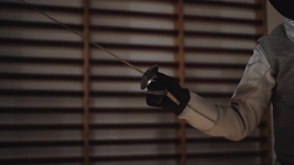Fencer Thrusting Foil At Opponent Before Removing Mask alt