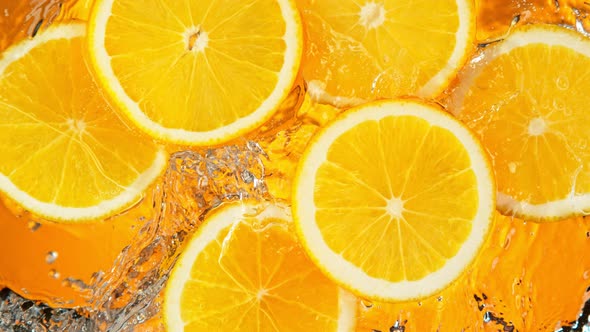 Super Slow Motion Shot of Splashing Fresh Orange Slices Into Water at 1000 Fps alt
