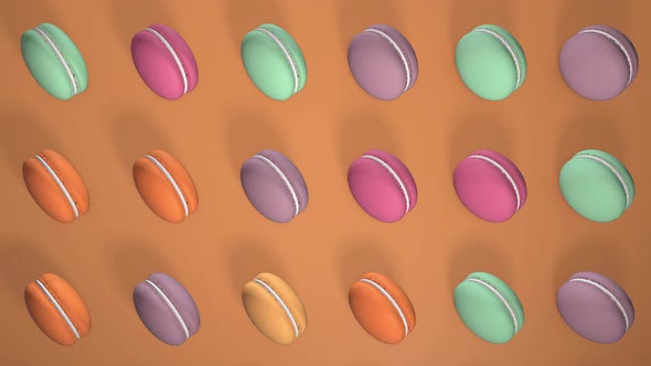 Multicolored macaron pastries photographed on light Orange paper background