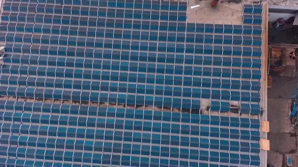 Solar Panels Installed On Roof. Top down view of large area solar photovoltaic panels on rooftop alt