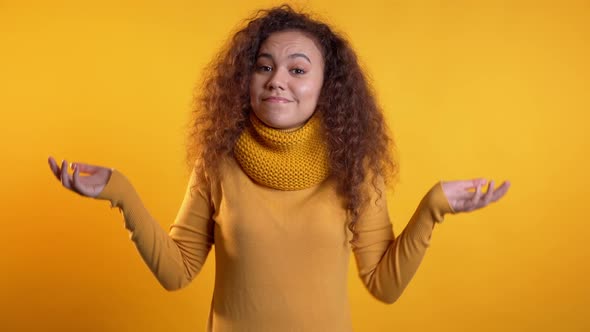  Young Unsure Girl Shrugs Her Arms, Makes Gesture of I Don't Know, Can't Help alt