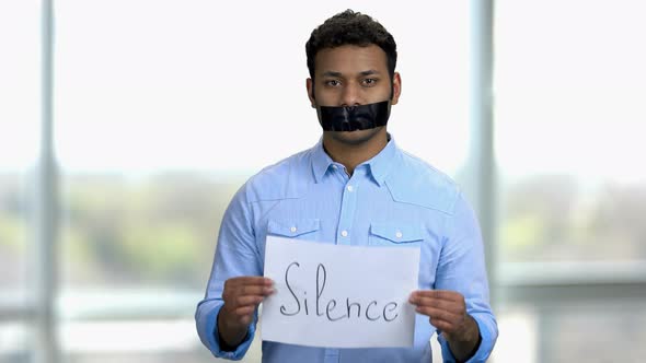 Silence Concept Young Indian Man with Taped Mouth alt