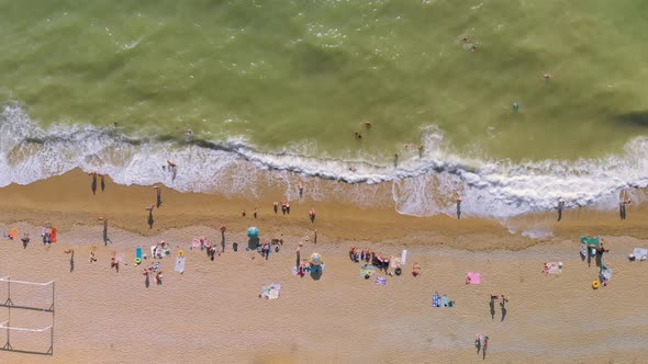 People on Sea Shore Ocean at Hot Sunny Day