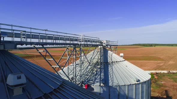 Aerial view. Metal grain elevator in agricultural zone. Grain warehouse alt