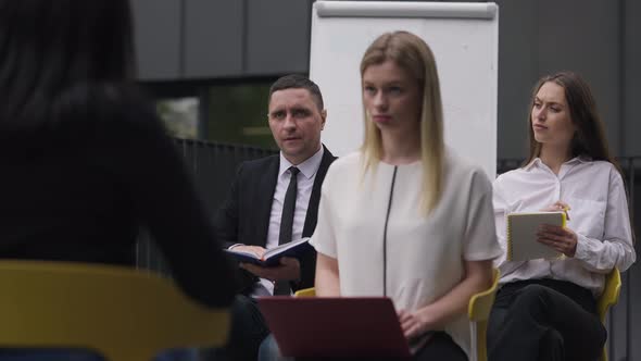 Confident Man Raising Hand at Business Meeting Standing Up Talking in Slow Motion alt