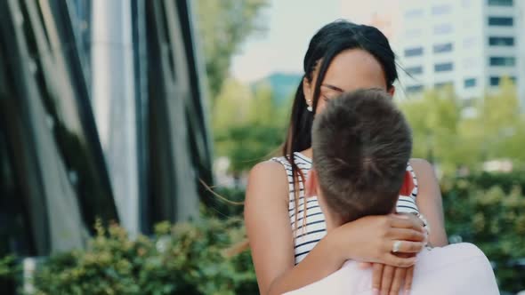 Happy Young Man Spinning Around His Mixedrace Girlfriend in a Beautiful Place Outdoors alt