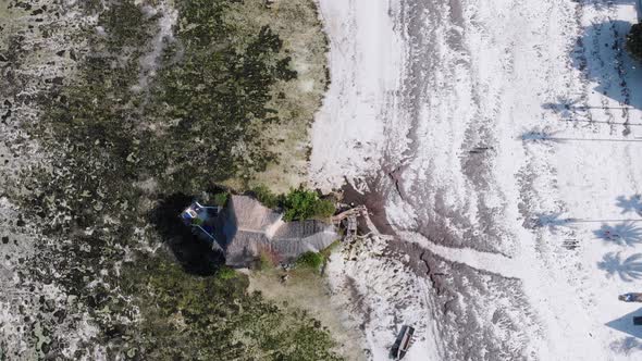 The Rock Restaurant in Ocean Built on Cliff at Low Tide on Zanzibar Aerial Top alt