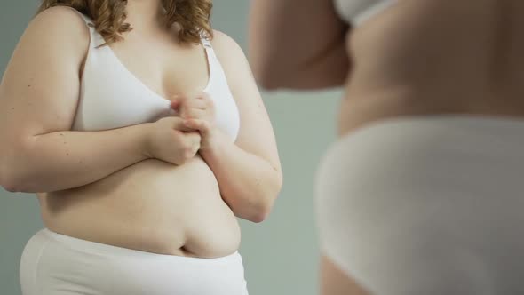 Shy Girl Studying Her Body in Mirror, Dissatisfied and Nervous With Reflection alt