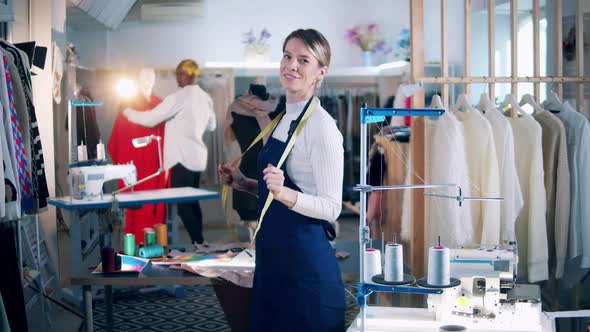 Seamstress is Dancing in the Workshop with a Male Tailor Nearby alt